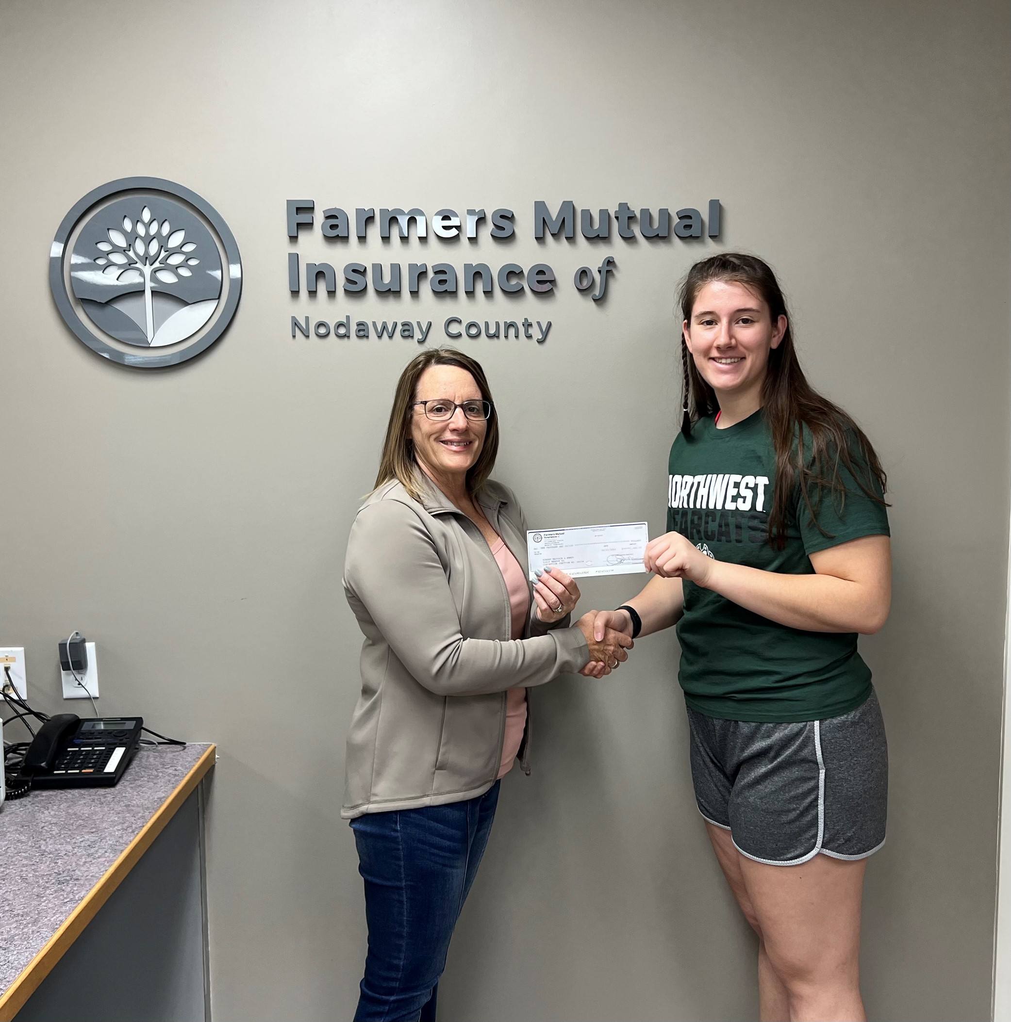 FM Nodaway agent Tricia Wiederholt presents scholarship award to Aubery Mattson